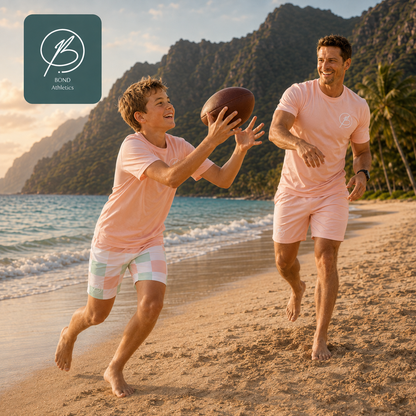 A man and a boy play with a football on a tropical beach, wearing matching light pink athletic t-shirts and shorts. A teal Brand Affixes logo is visible in the top-left corner.